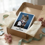 High School Photo Pet Notebook. The white hardcover notebook half-unwrapped from cream tissue paper in a kraft gift box on a pale wooden table.