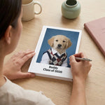 High School Photo Pet Notebook. Over-the-shoulder view of a person writing in the white hardcover notebook at a pale oak desk, cropped at the shoulders.
