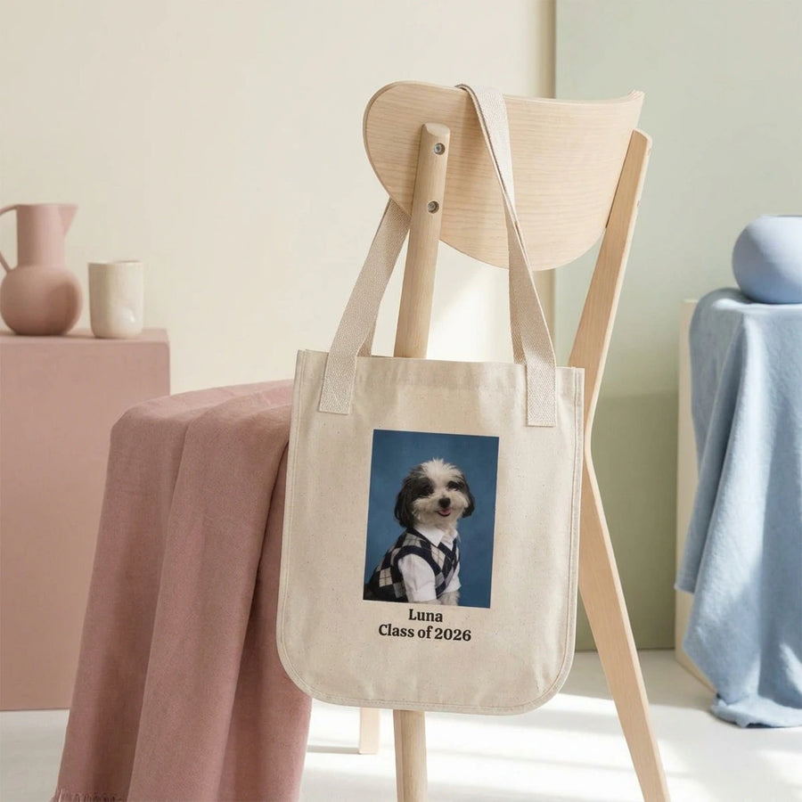 High School Photo Pet Tote Bag. The natural canvas tote bag slung over the back of a pale wooden chair in a bright minimal room.