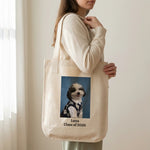 High School Photo Pet Tote Bag. A person holding the natural canvas tote bag in front of them with both hands, cropped from the chin down, cream wall behind.