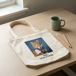 High School Photo Pet Tote Bag. The natural canvas tote bag lying flat on a pale oak desk beside a sage mug and two sharpened pencils.
