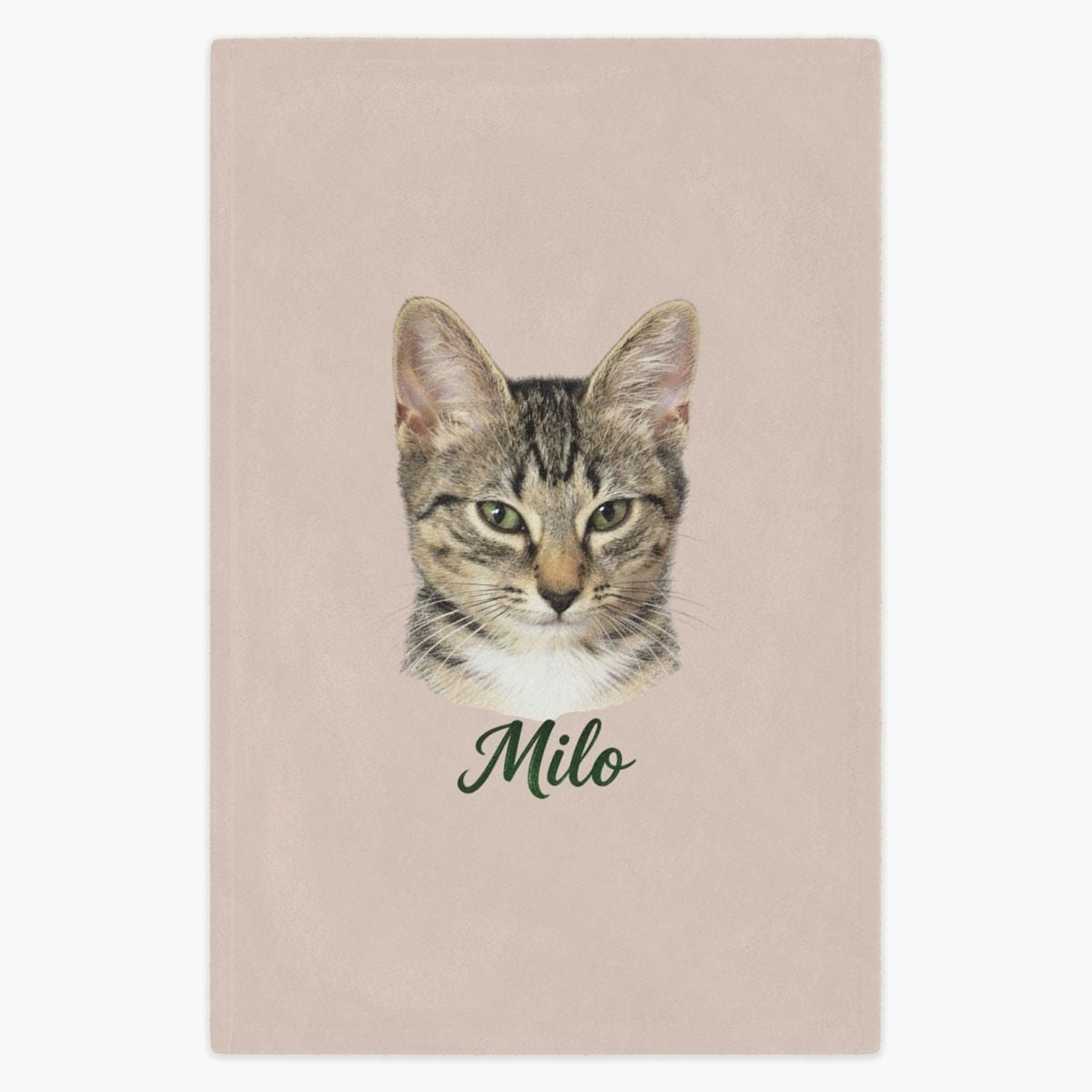 Colored pencil portrait of a tabby cat printed on a dusty pink fleece blanket, with the name "Milo" drawn below.