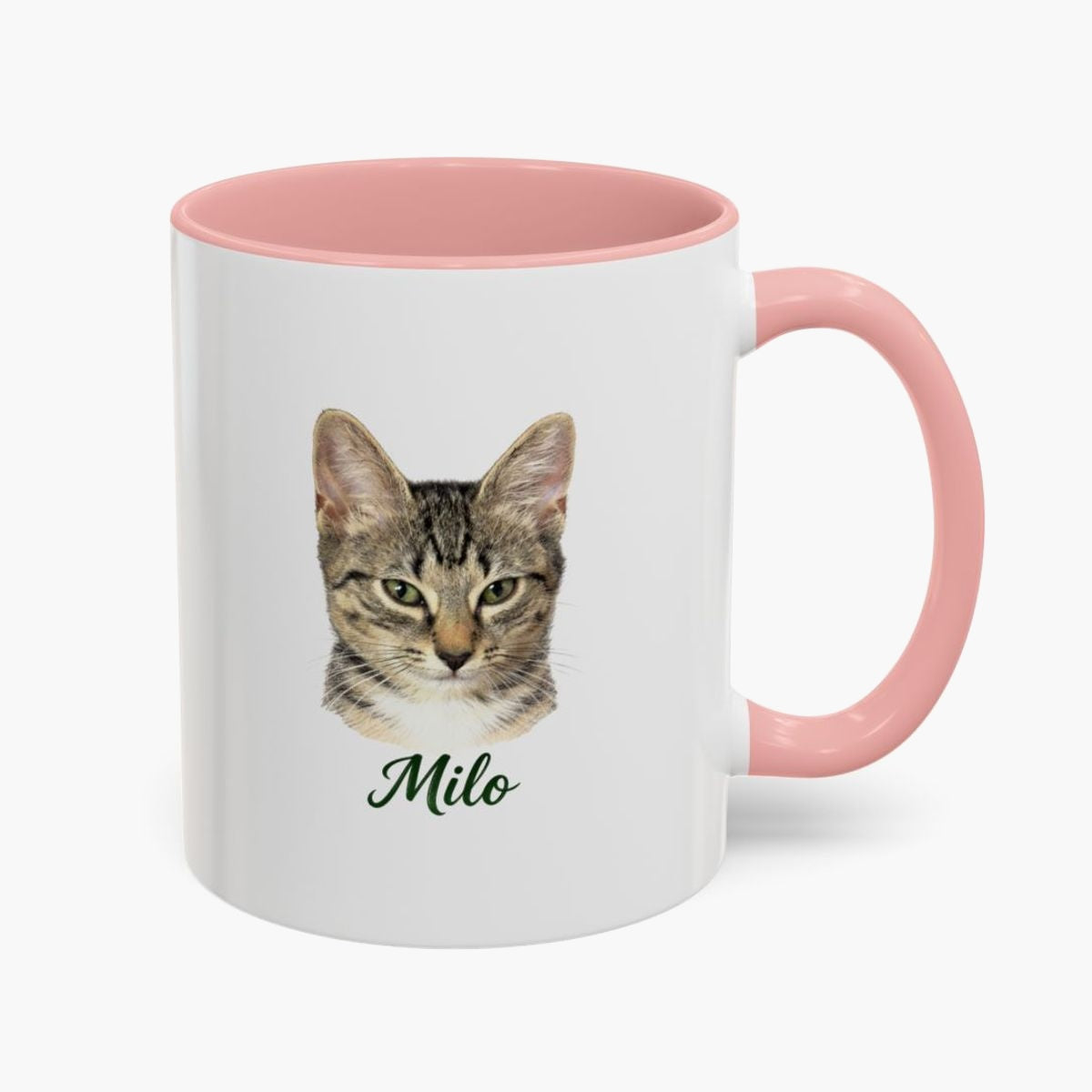 Colored pencil portrait of a tabby cat on a 11 oz mug with a pink handle, with the name "Milo" drawn below.