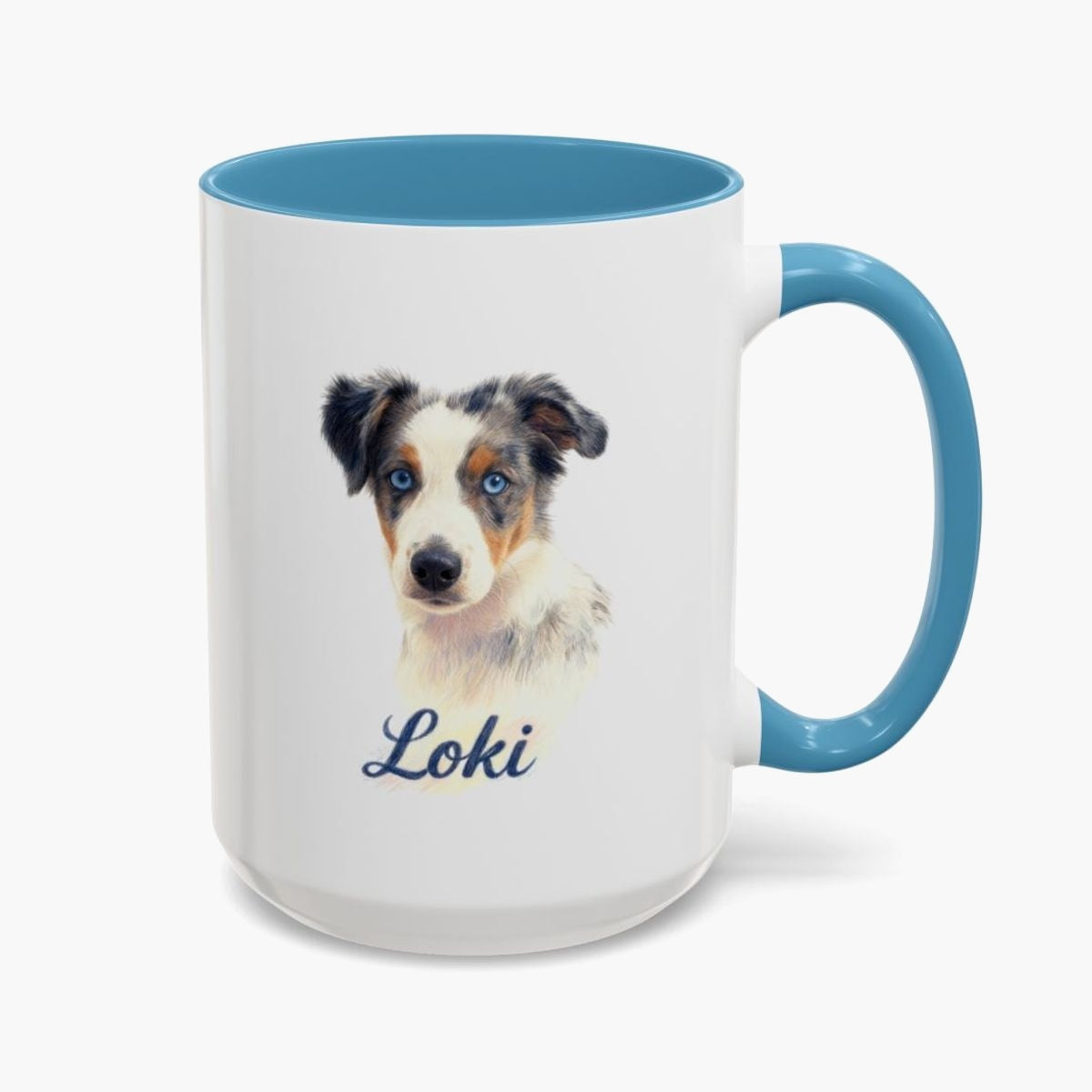 Colored pencil portrait of a blue merle Australian shepherd puppy on a 15 oz mug with a light blue handle, with the name "Loki" drawn below.