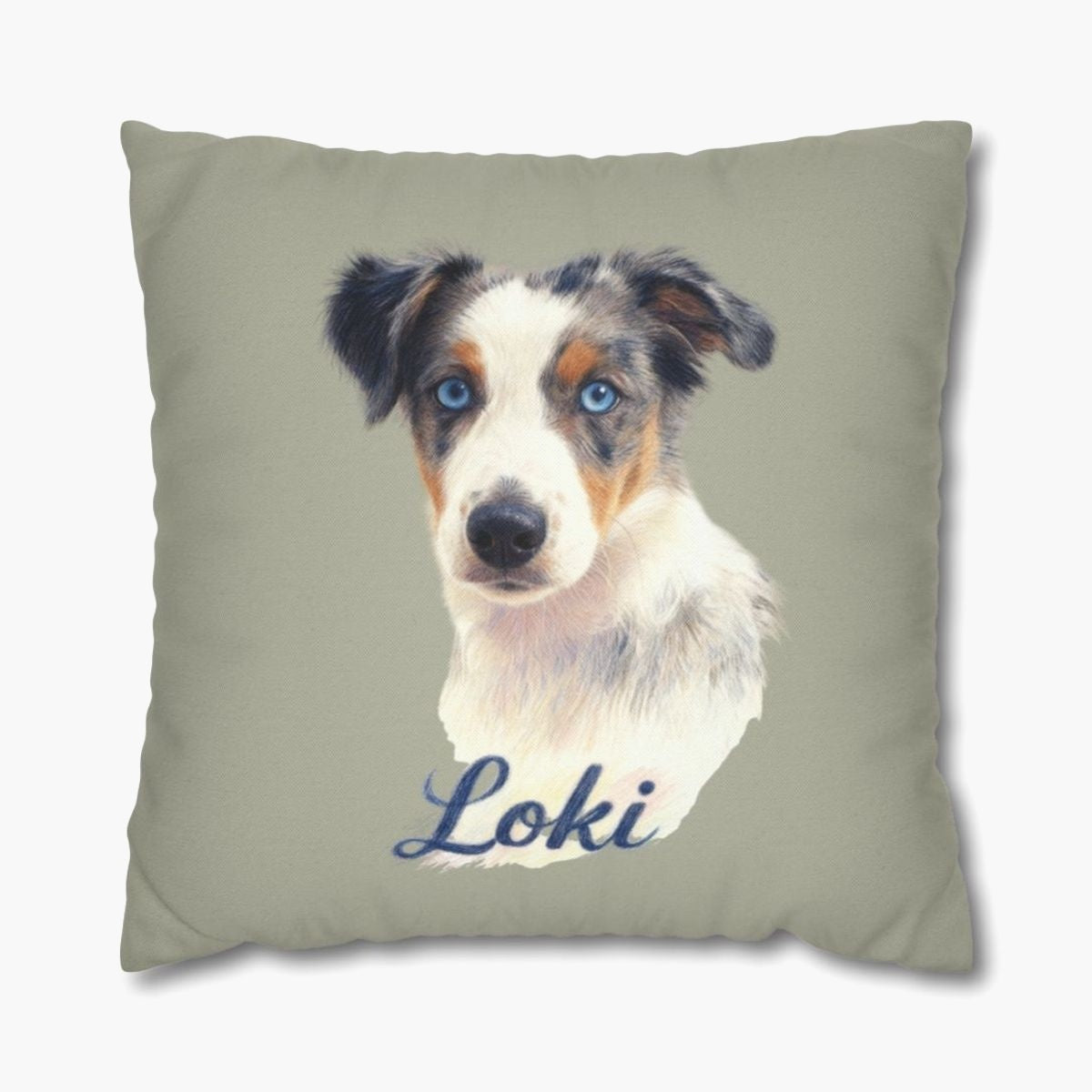 Colored pencil portrait of a blue merle Australian shepherd puppy on a sage 18-inch throw pillow, with the name "Loki" drawn below.