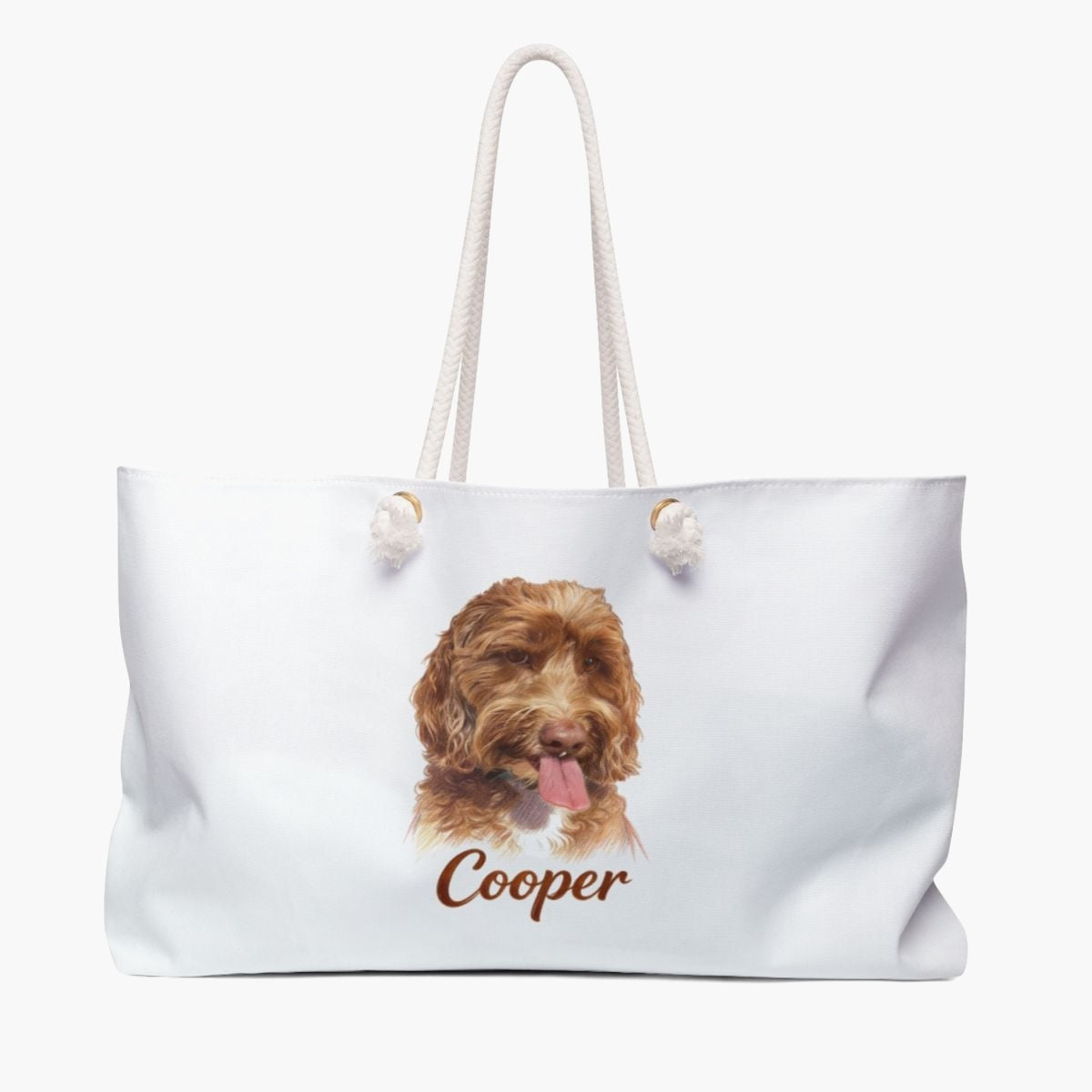 Colored pencil portrait of an apricot labradoodle on a soft white weekender bag with white rope handles, with the name "Cooper" drawn below.