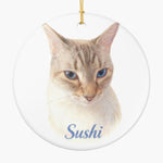 Round white ceramic ornament printed with a pencil-drawn cat portrait and the pet's name below it