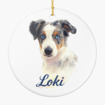 Round white ceramic ornament printed with a pencil-drawn dog portrait and the pet's name below it